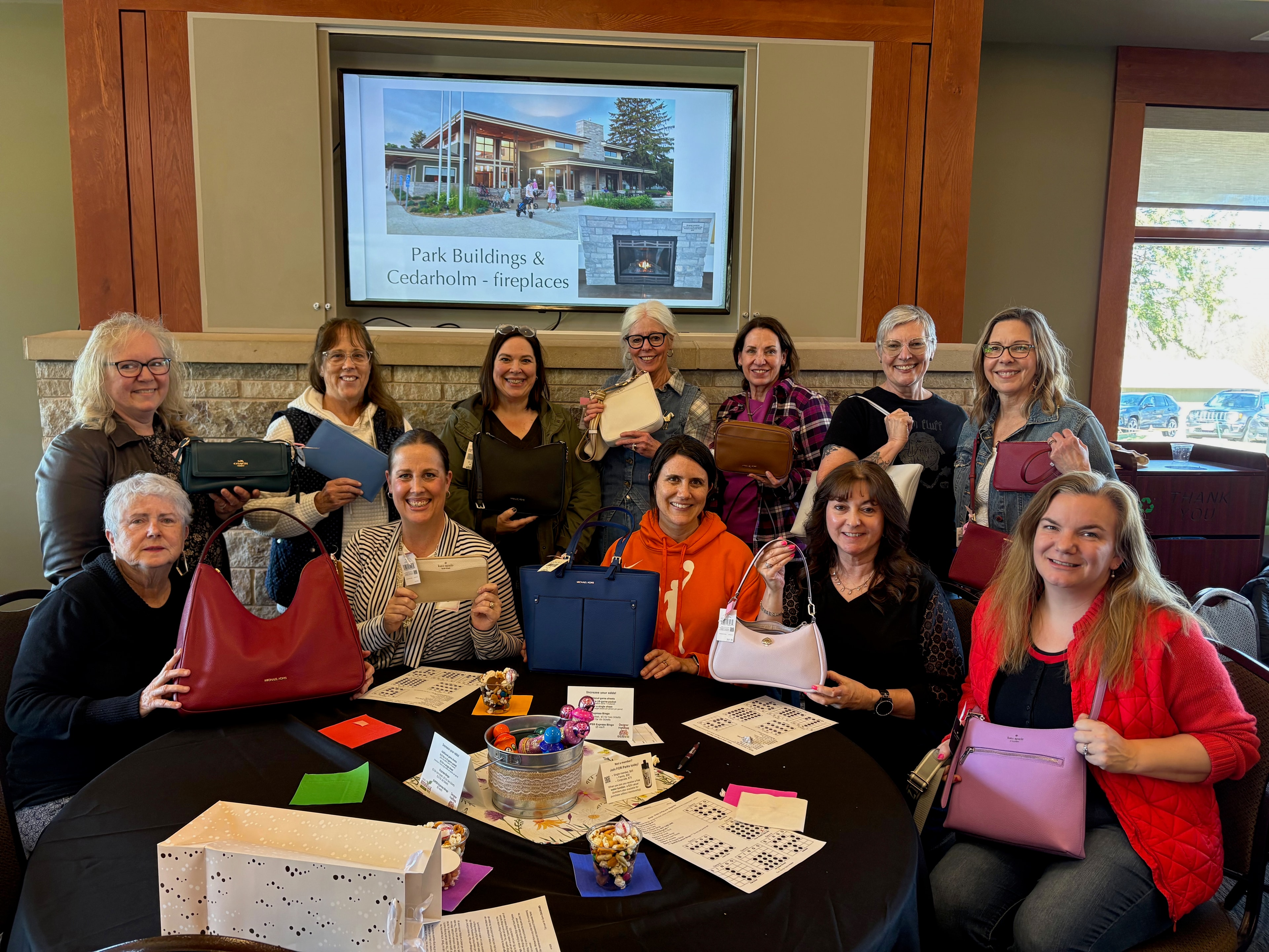Spring 2026 Bingo winners holding designer handbags