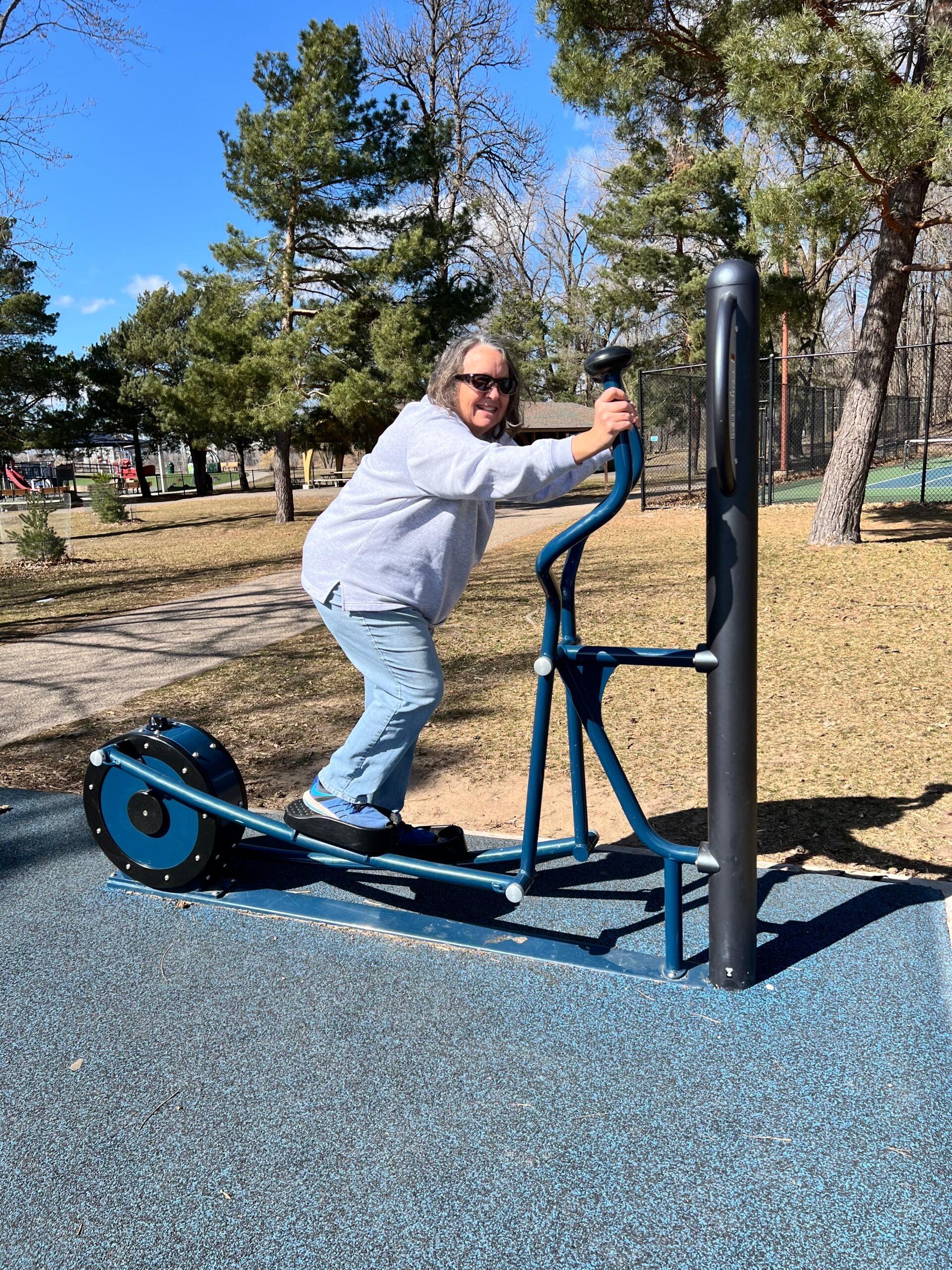 Person using outdoor adult fitness equipment at a Roseville park