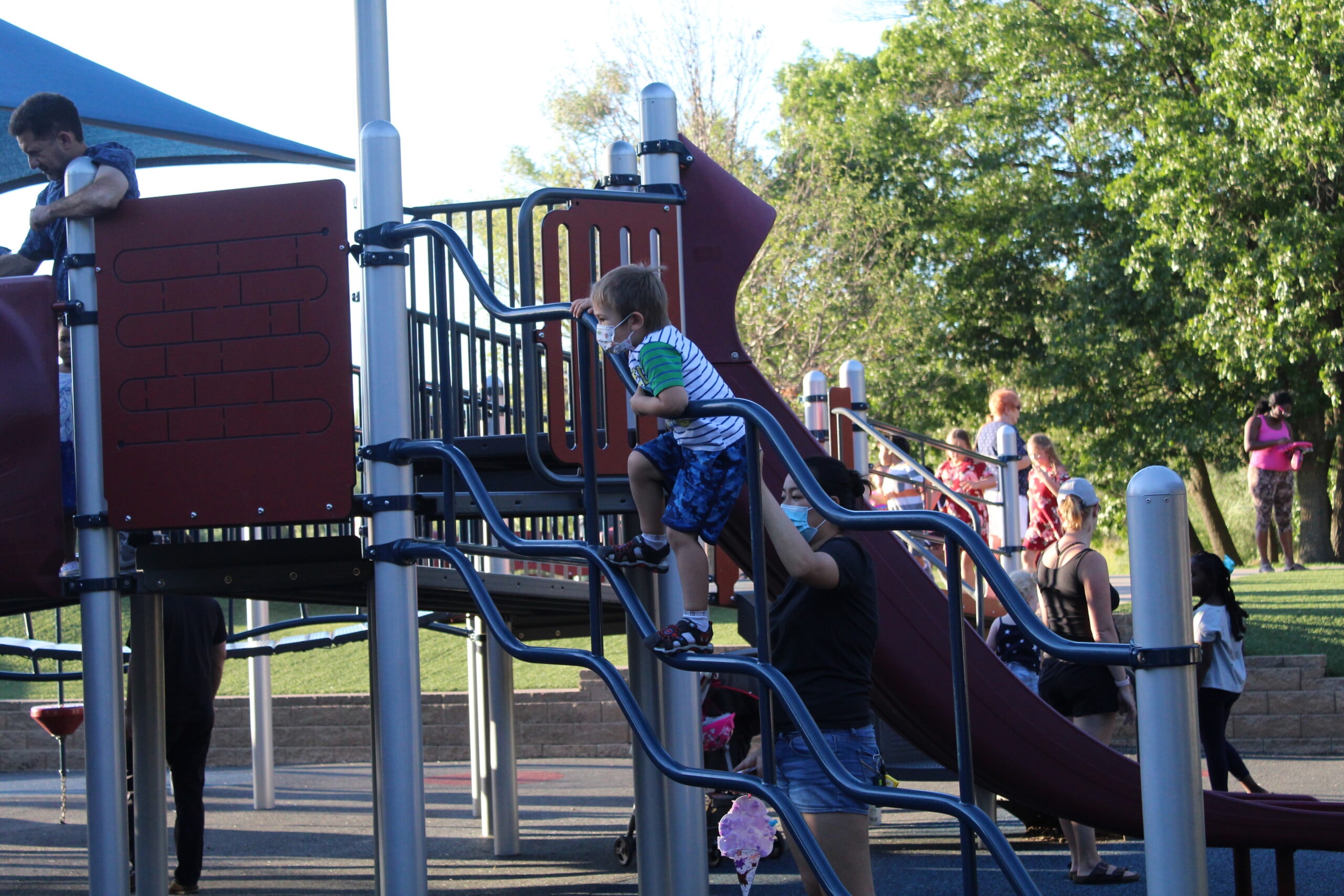 Children playing on playground equipment at a Roseville park
